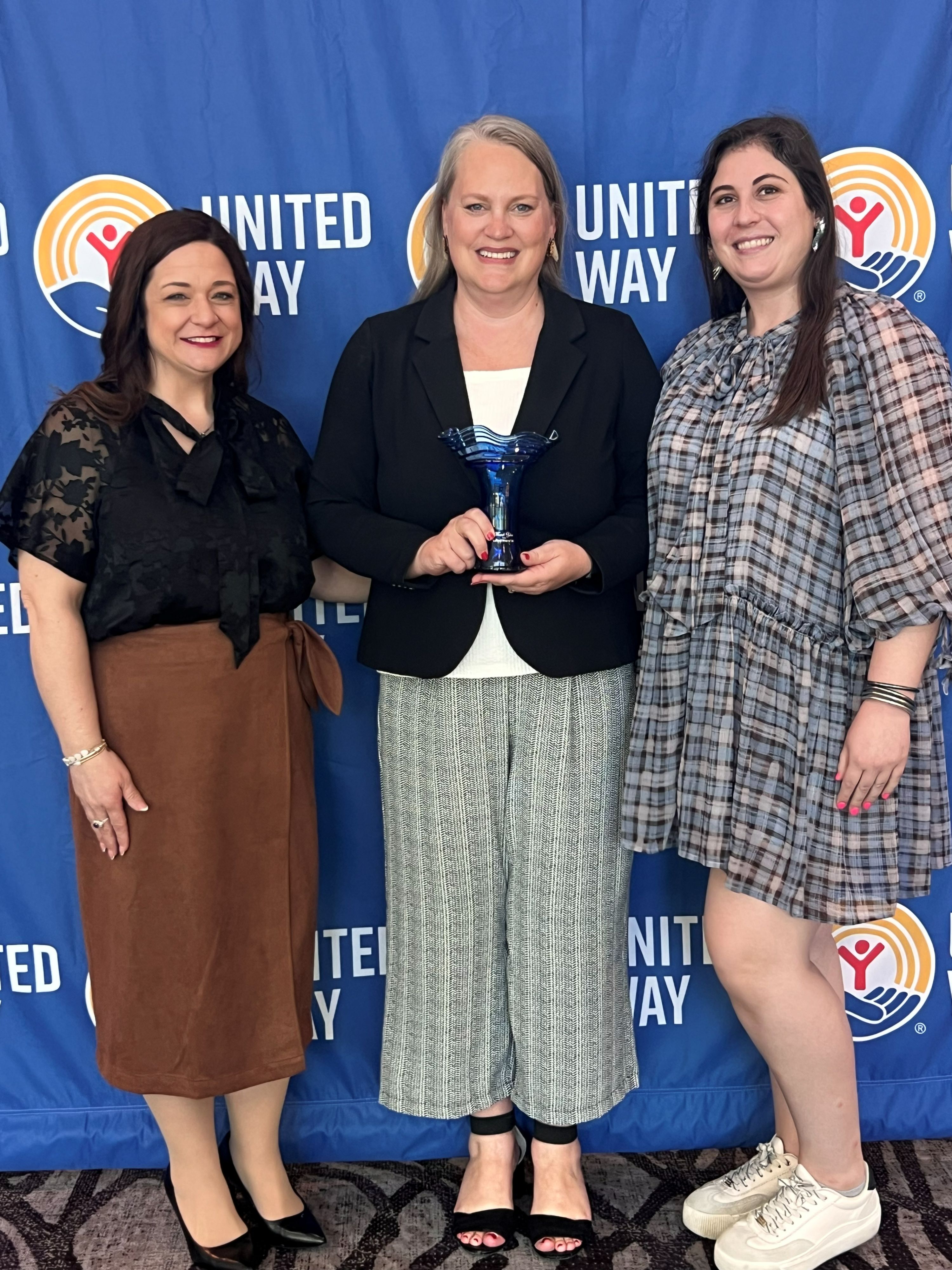Jessica Munday Awarded for Helene recovery efforts with UWNC, posing with Brittany Pruitt Fletcher and Sara Carlson of UWNC