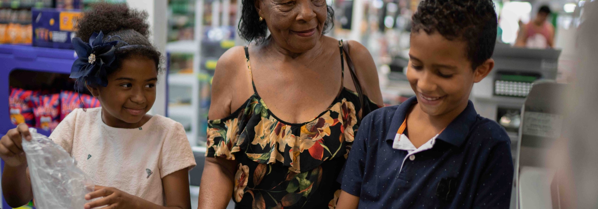 A grandmother and her grandkids purchasing groceries